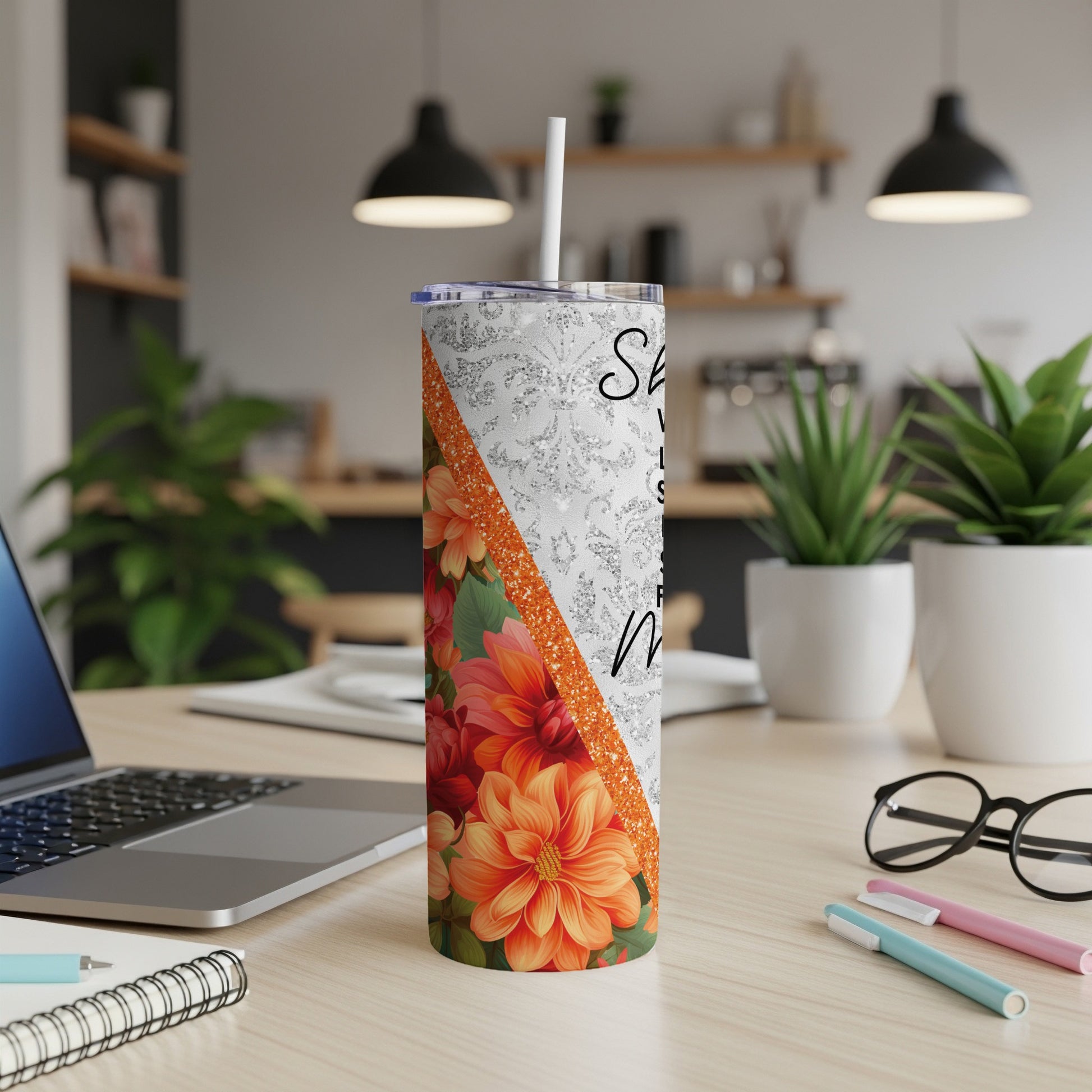 Silver glitter tumbler with orange floral pattern and white text.