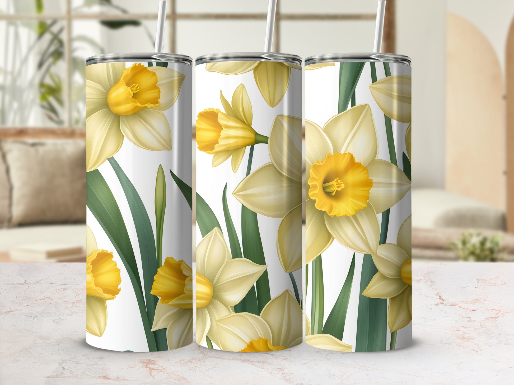 Yellow daffodils and green leaves on three tall tumblers.