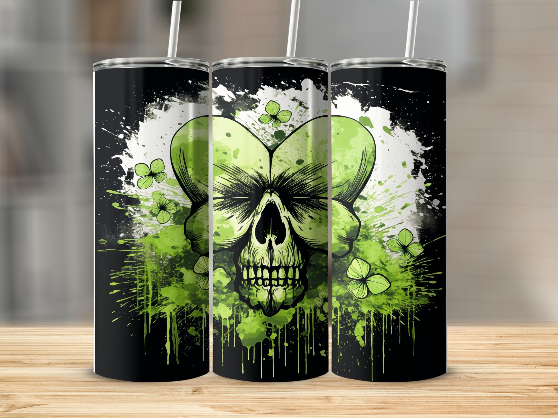 Three tumblers with a green skull and shamrocks against a black, splattered background.