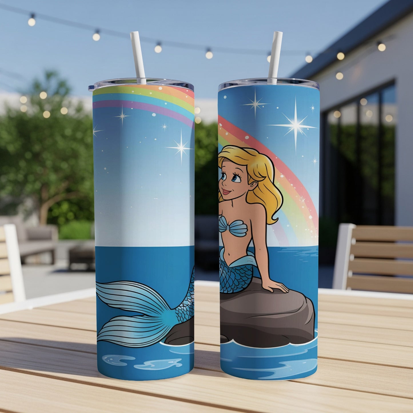 Two tumblers with a cartoon mermaid on a rock with a rainbow.