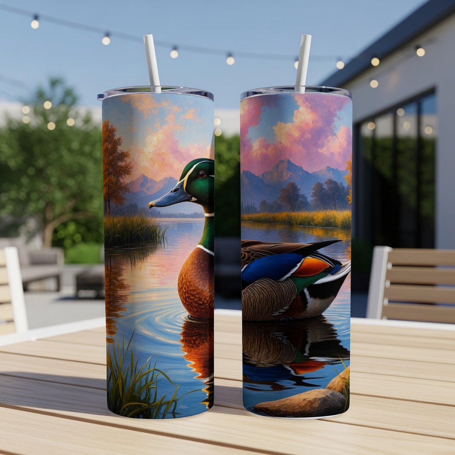 Mallard duck on water with colorful sky and mountains, on a tumbler.