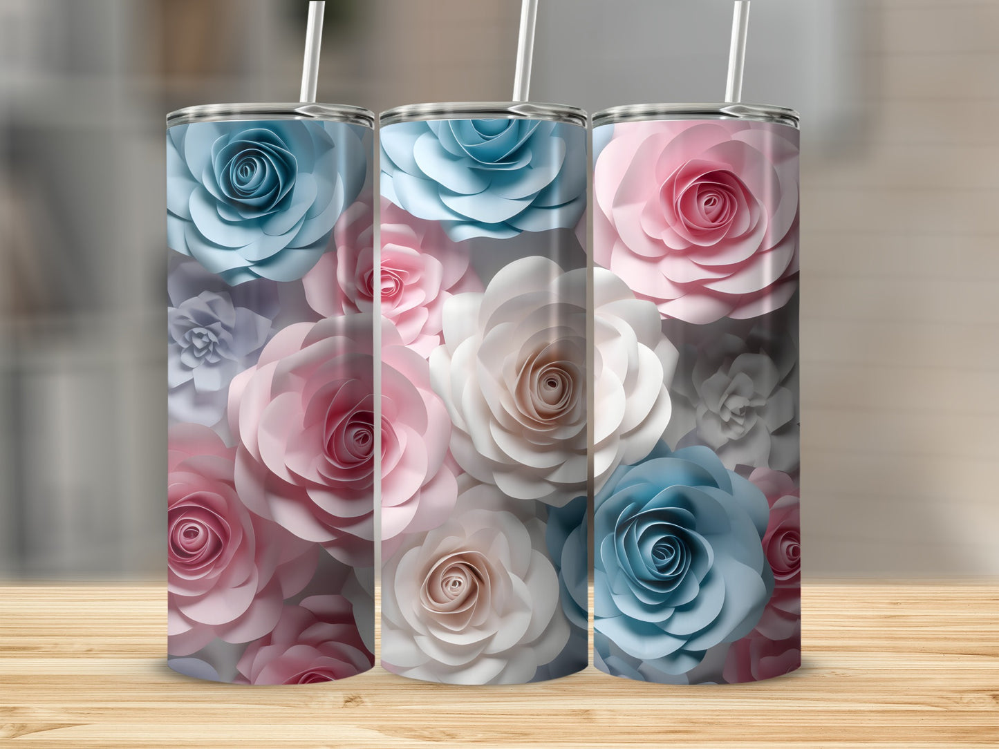Three tumblers with floral designs in pink, blue, and white.