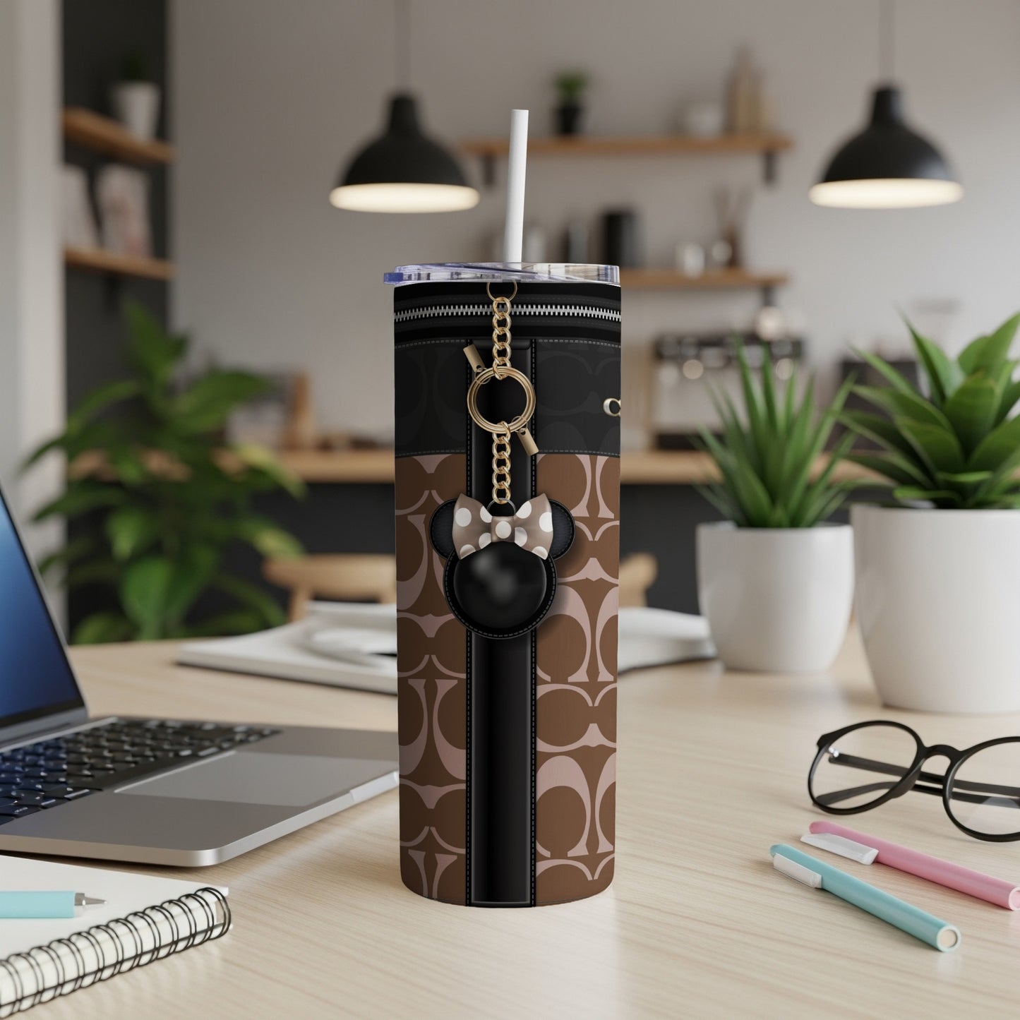 Tumbler with brown geometric pattern, black trim, and Minnie Mouse charm.