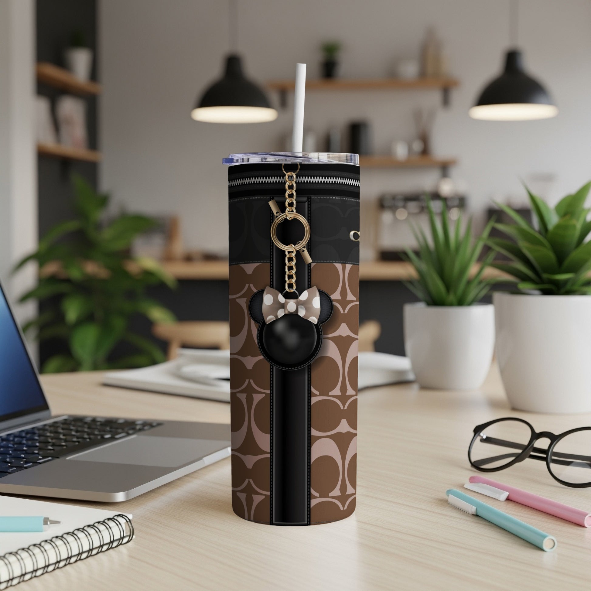 Tumbler with brown geometric pattern, black trim, and Minnie Mouse charm.