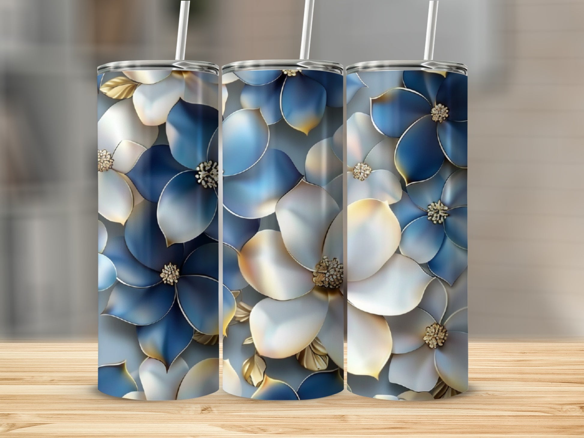 Three tumblers with a blue and white floral design and gold accents.