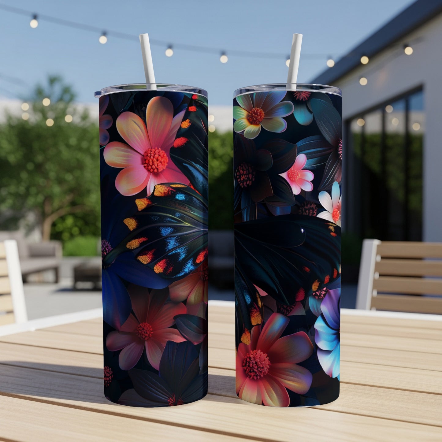 Two tumblers with vibrant floral and butterfly designs on a table.