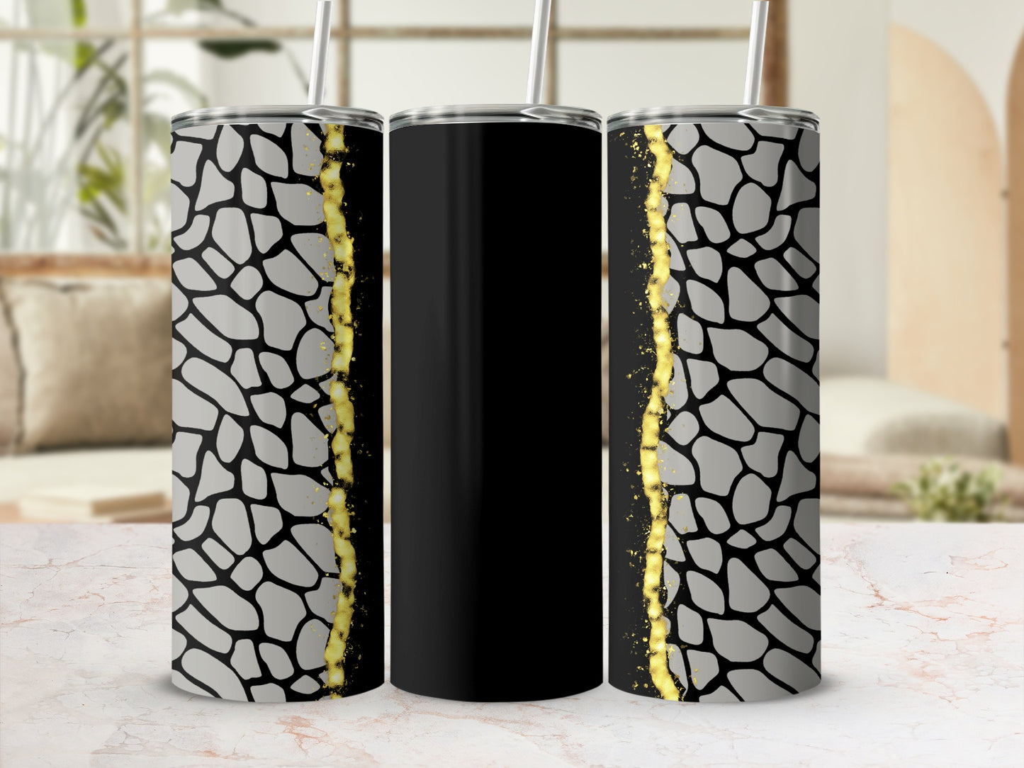 Black tumbler with grey giraffe print and gold glitter accent.