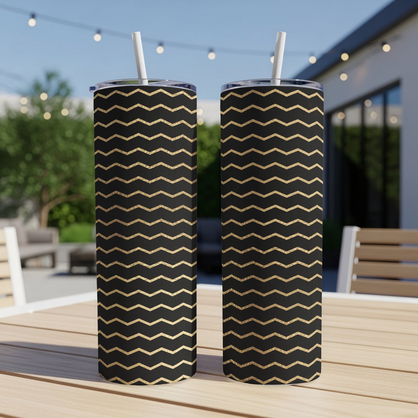 Two black tumblers with gold chevron pattern, each with a straw.