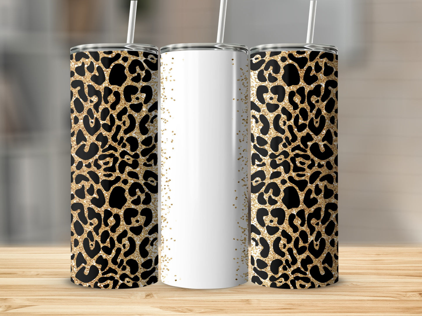 Three leopard print tumblers with gold glitter accents and white sections.