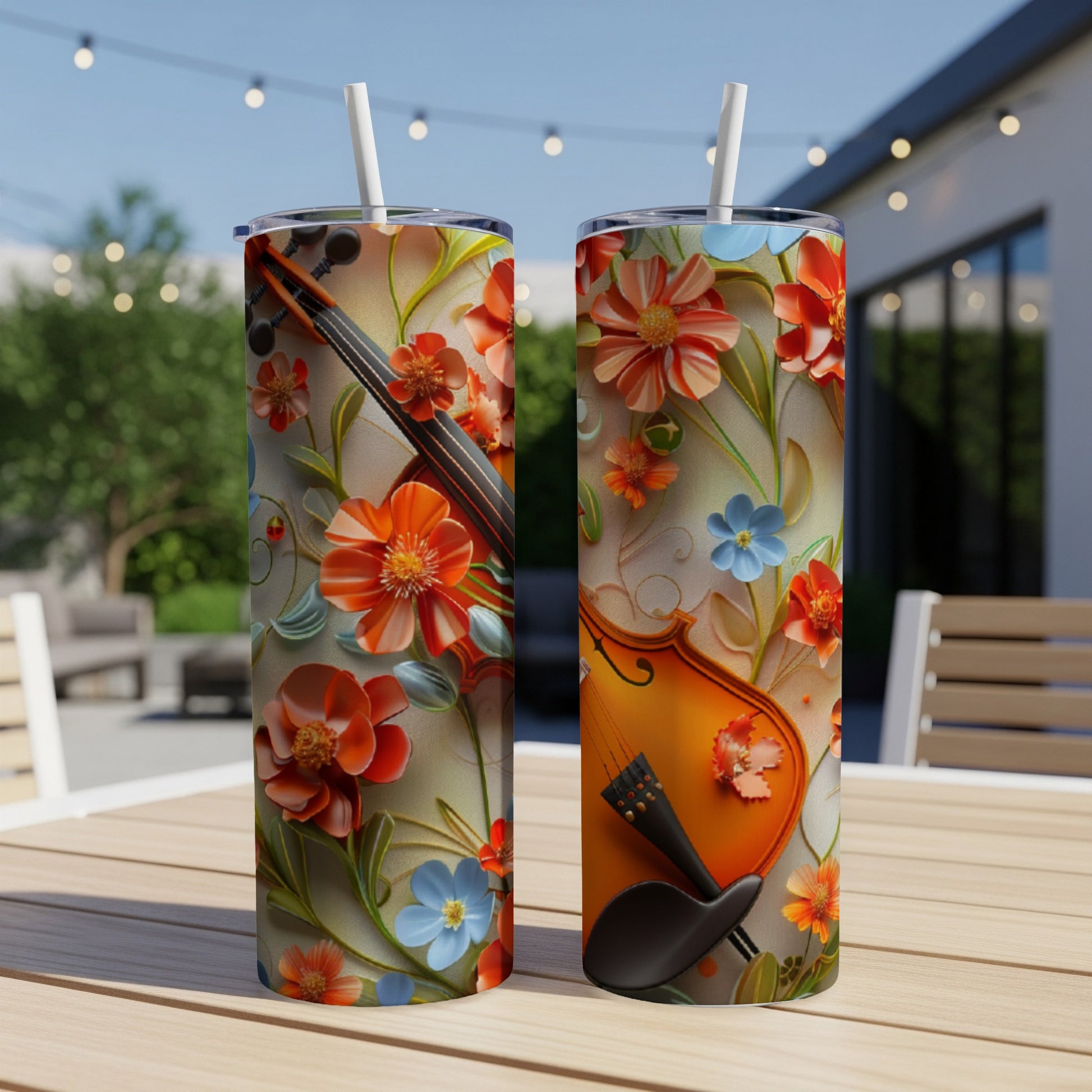 Two tumblers with a violin and colorful floral design on a table.