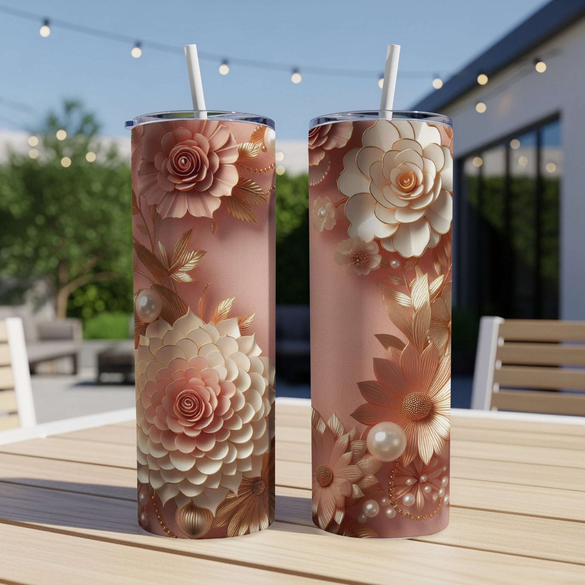 Rose gold floral pattern on two tall, slim tumblers with straws.