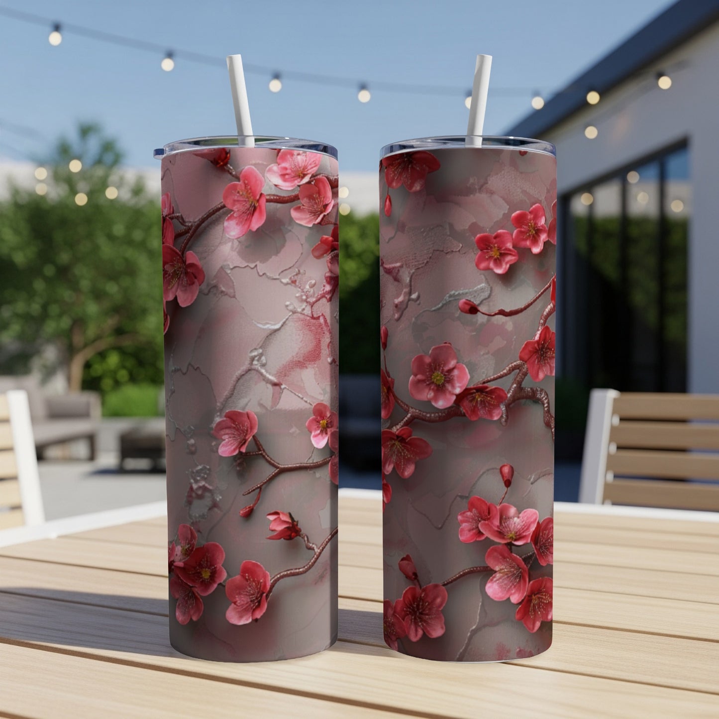 Two tall tumblers with a pink cherry blossom floral pattern.