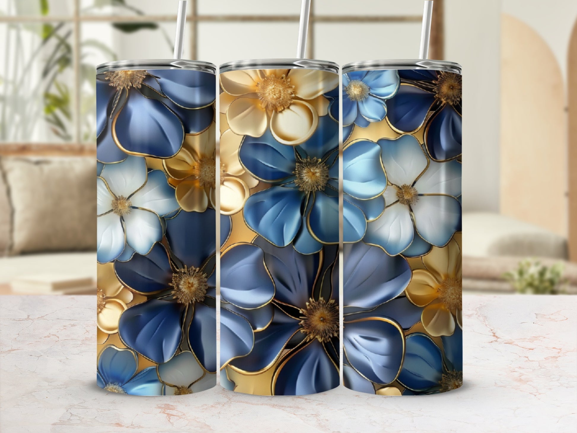Three tumblers featuring blue and white floral patterns with gold accents.