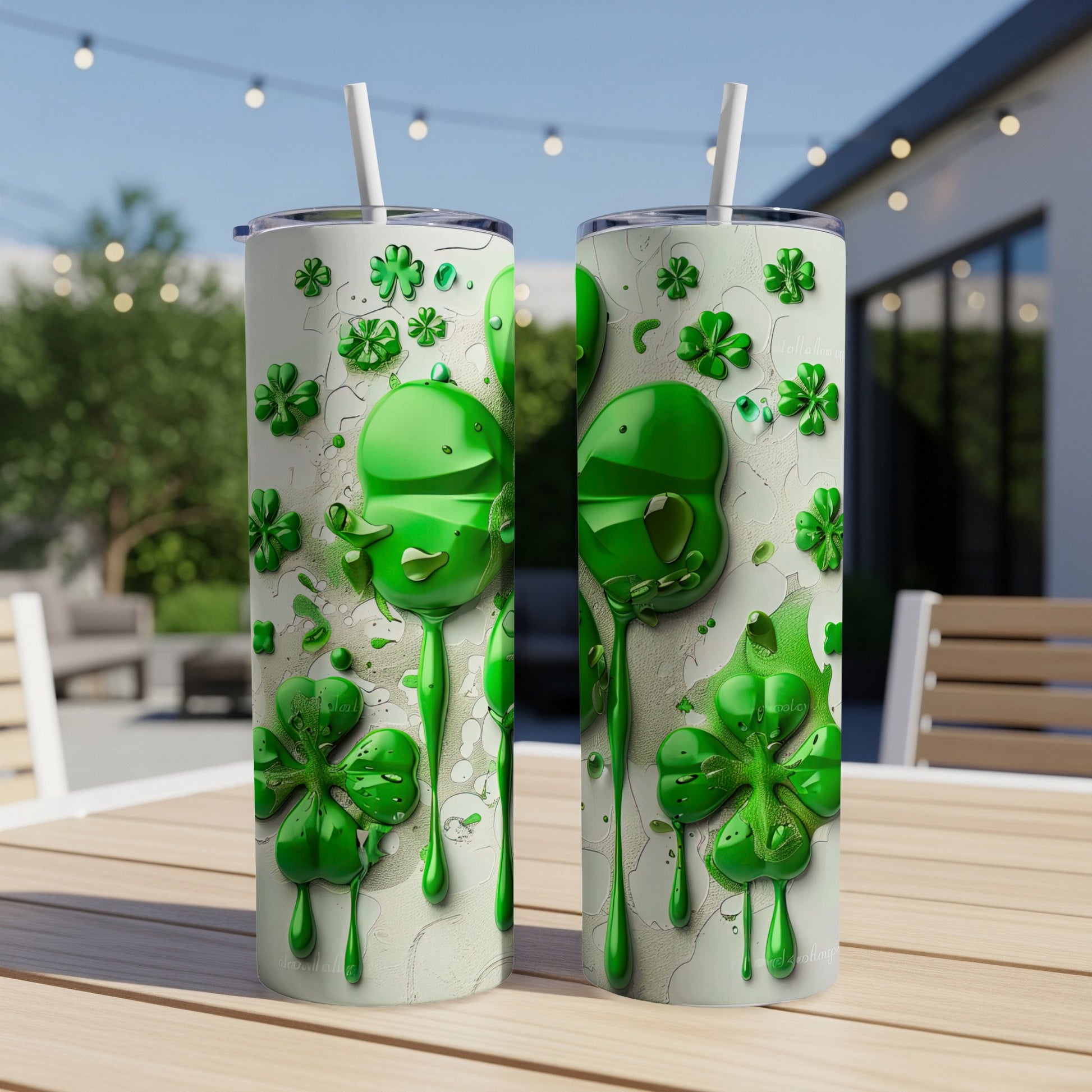 Two green shamrock-themed tumblers with straws on a table outdoors.