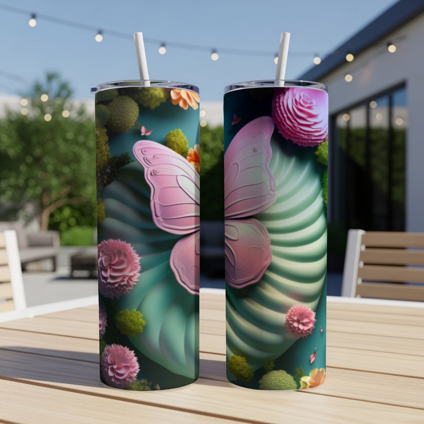Pink butterfly wing design on two tall, slender tumblers outdoors.