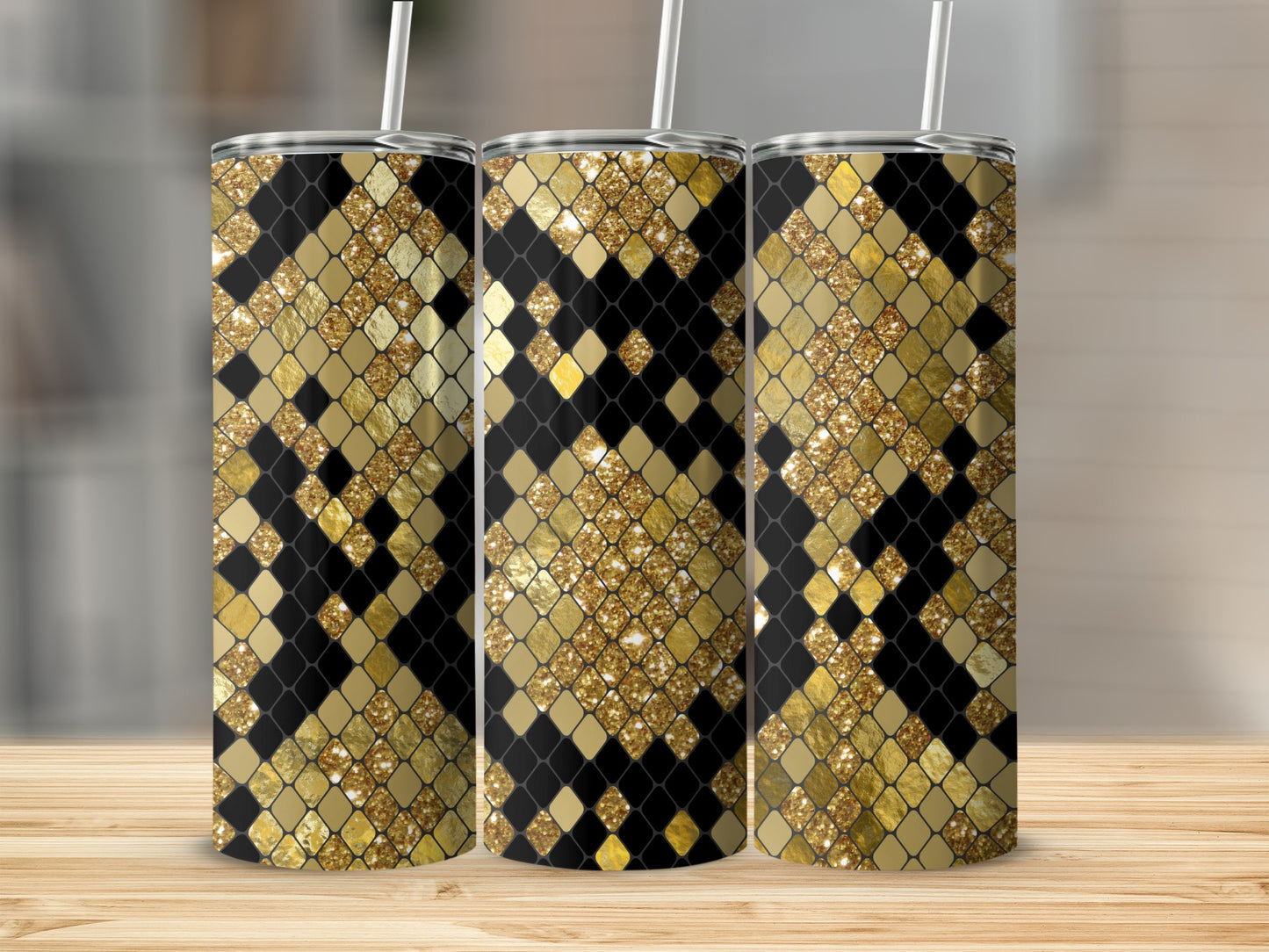 Three tumblers with a black and gold diamond scale pattern and white straws.