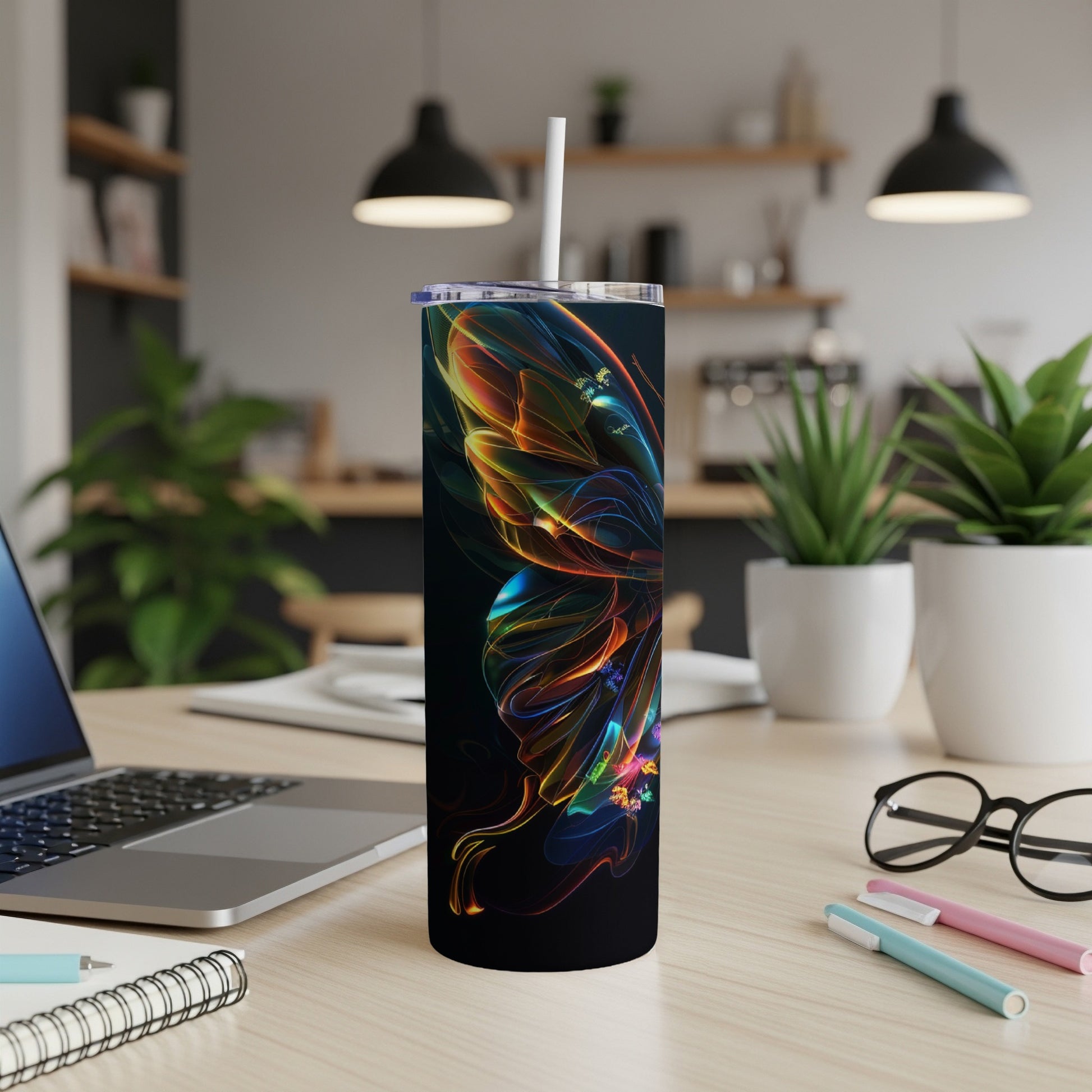 Tumbler with abstract butterfly design and straw.