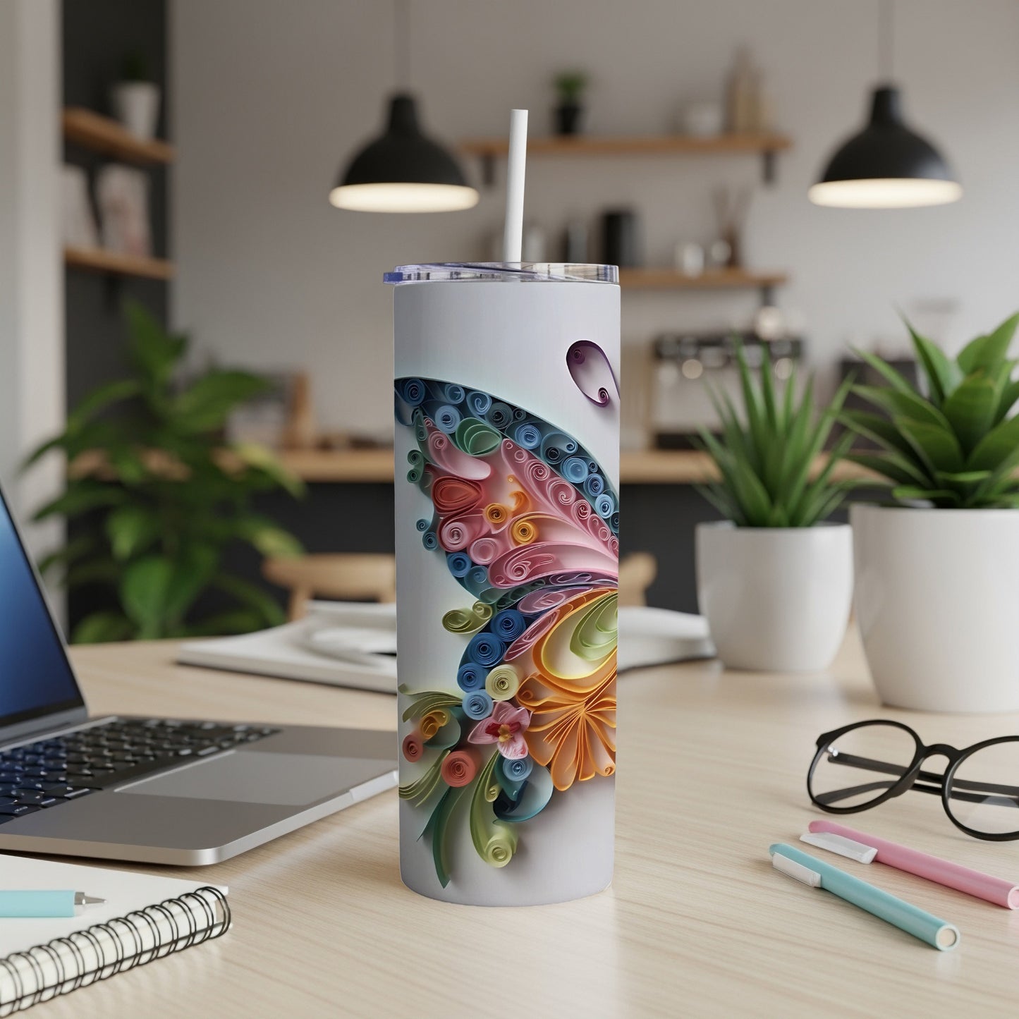 White tumbler with a colorful quilled butterfly design and a straw.