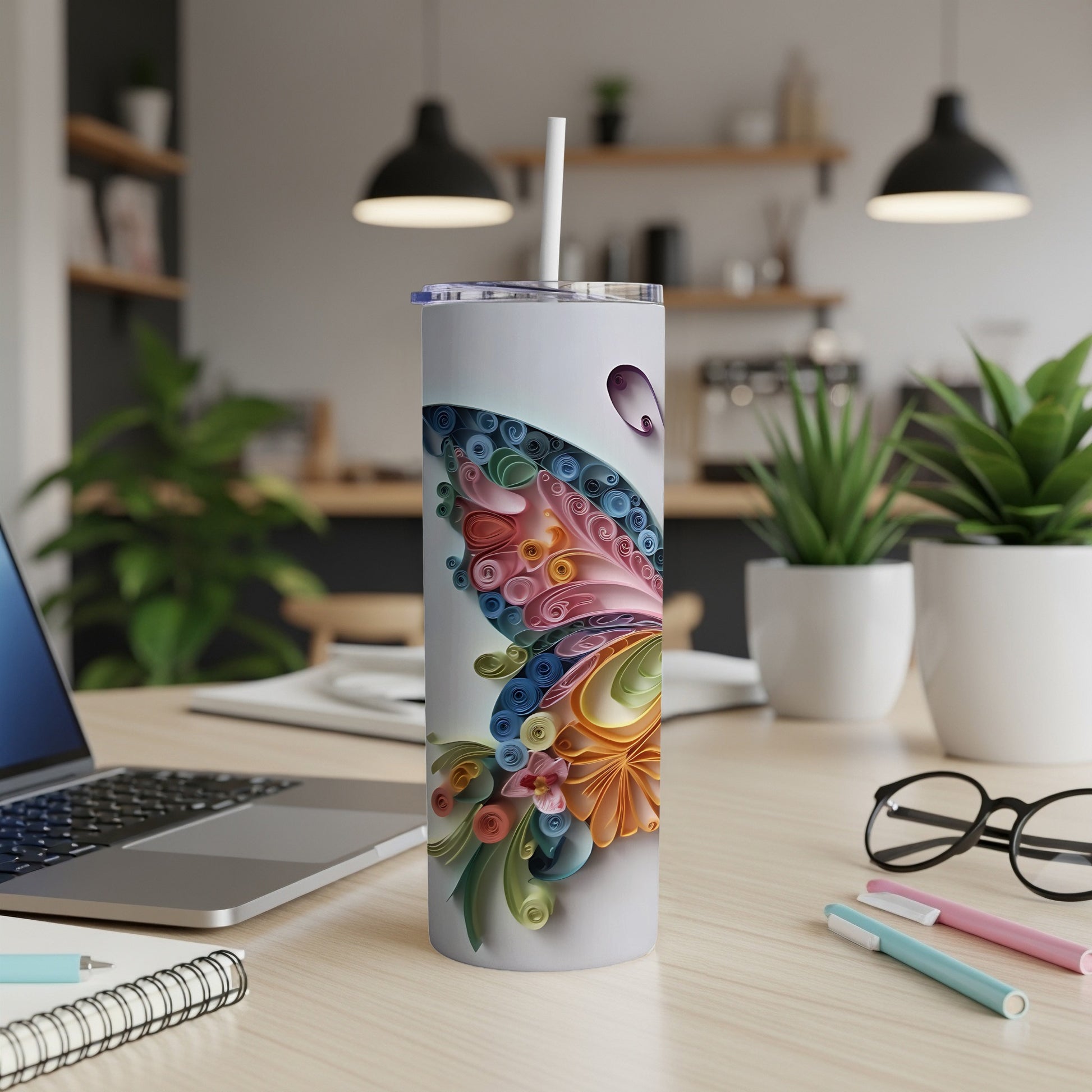 White tumbler with a colorful quilled butterfly design and a straw.