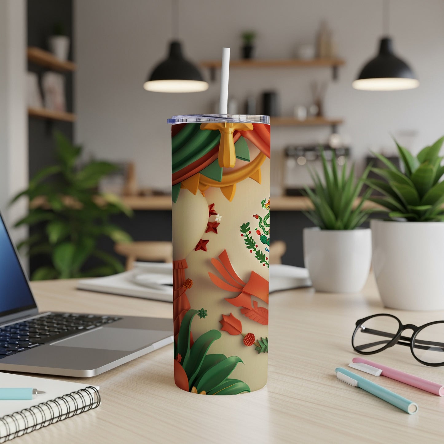 Mexican flag design tumbler with straw on a desk.