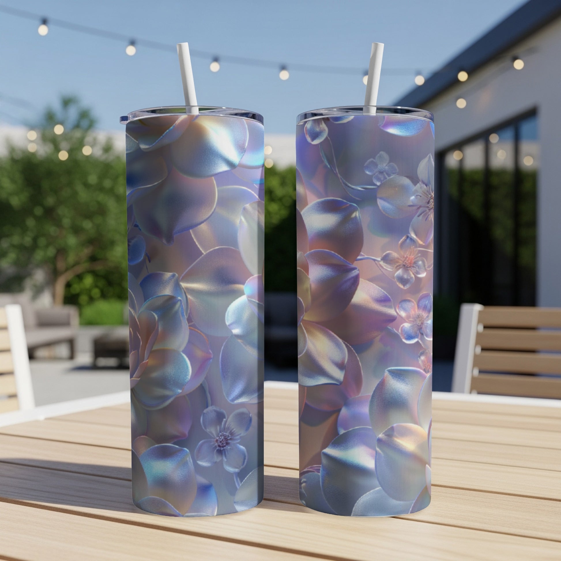 Two iridescent tumblers with floral patterns on a wooden table.