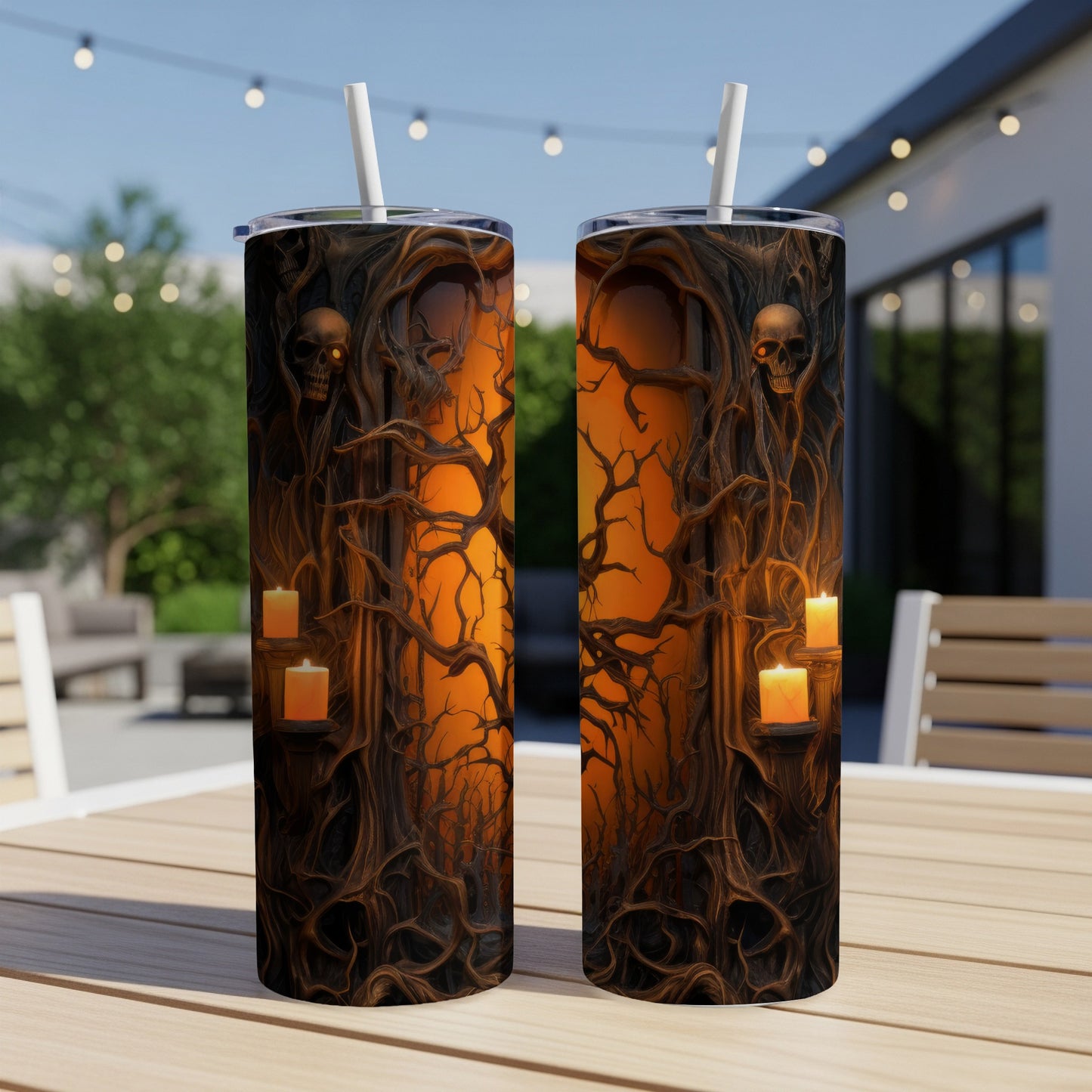 Two Halloween-themed tumblers with skulls, candles, and gnarled trees on an outdoor table.
