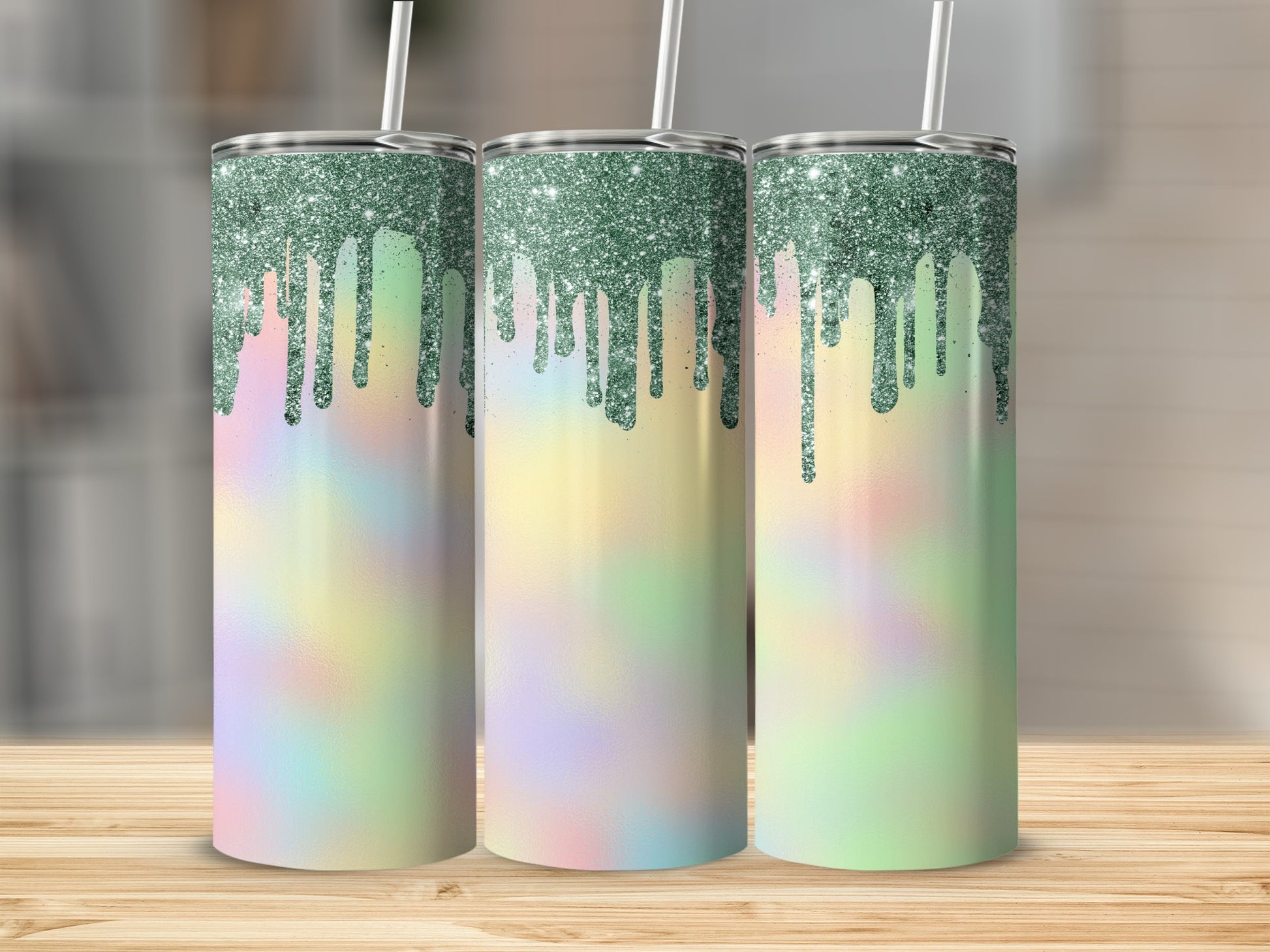 Three iridescent tumblers with green glitter drip design and straws.
