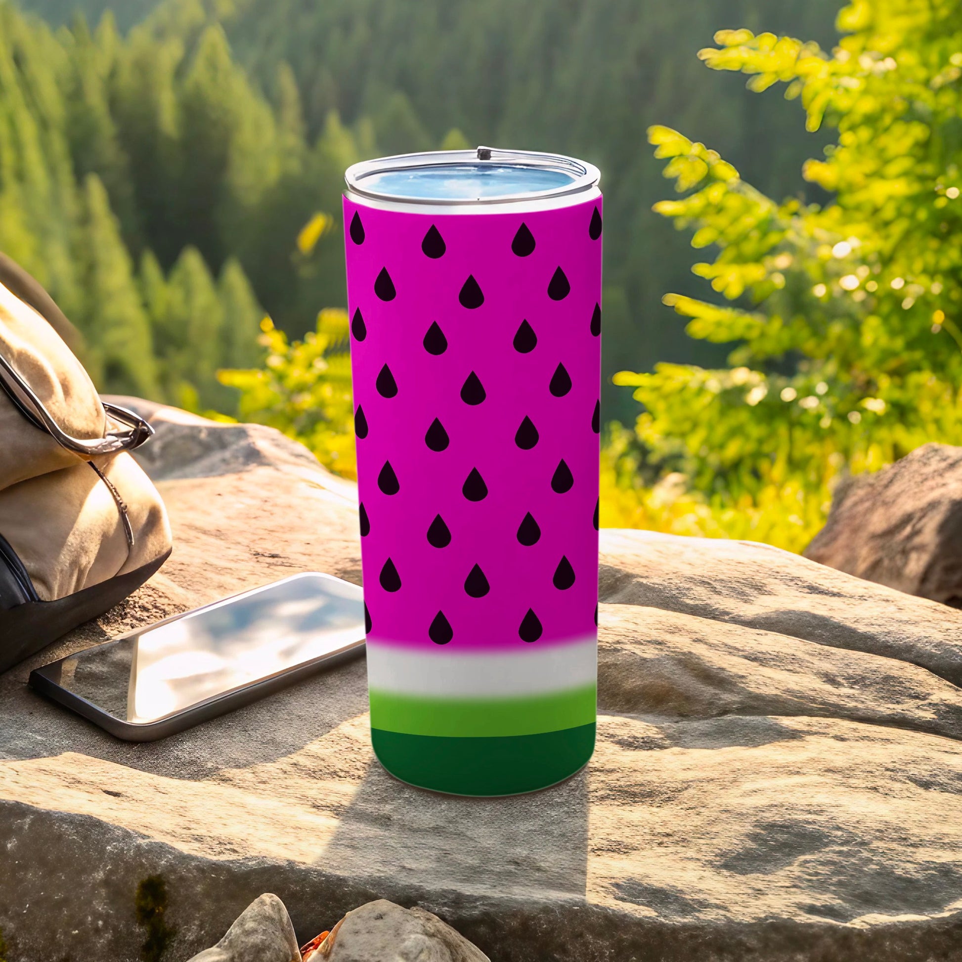 Pink tumbler with black watermelon seeds and green and white bands.