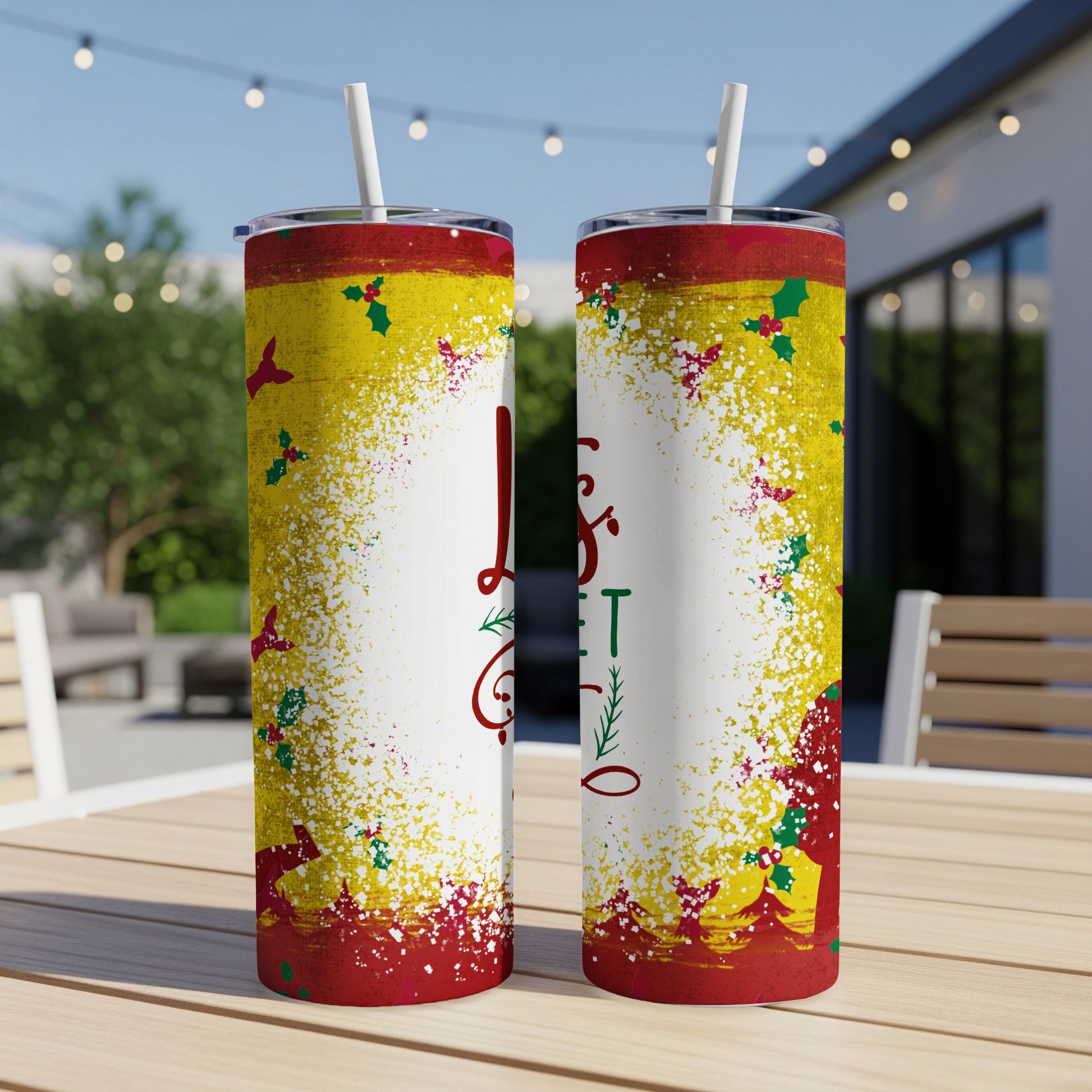 Two Christmas themed tumblers with "Tis the Season" text on a wooden table.