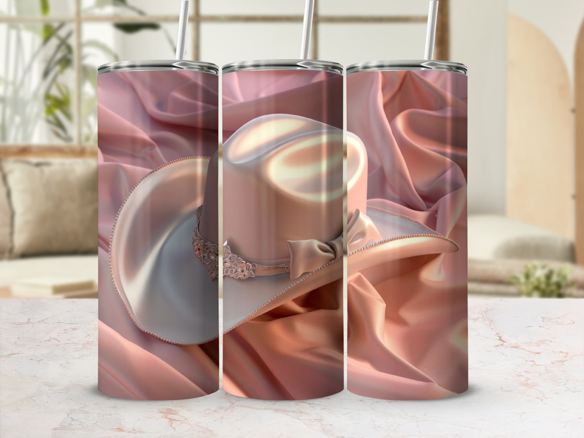 Pink cowboy hat tumbler with satin background and straw.