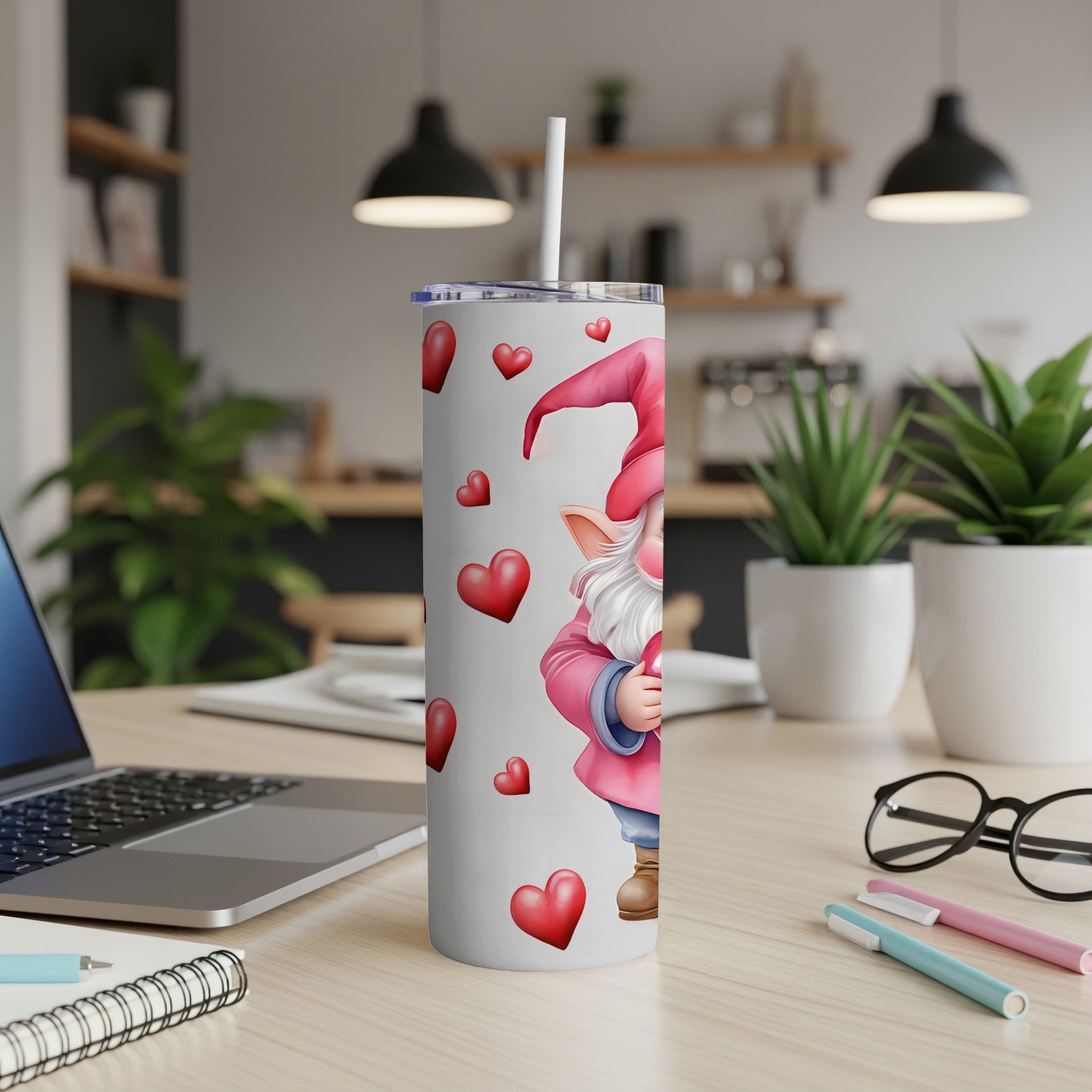 White tumbler with gnome and red hearts, straw inserted.