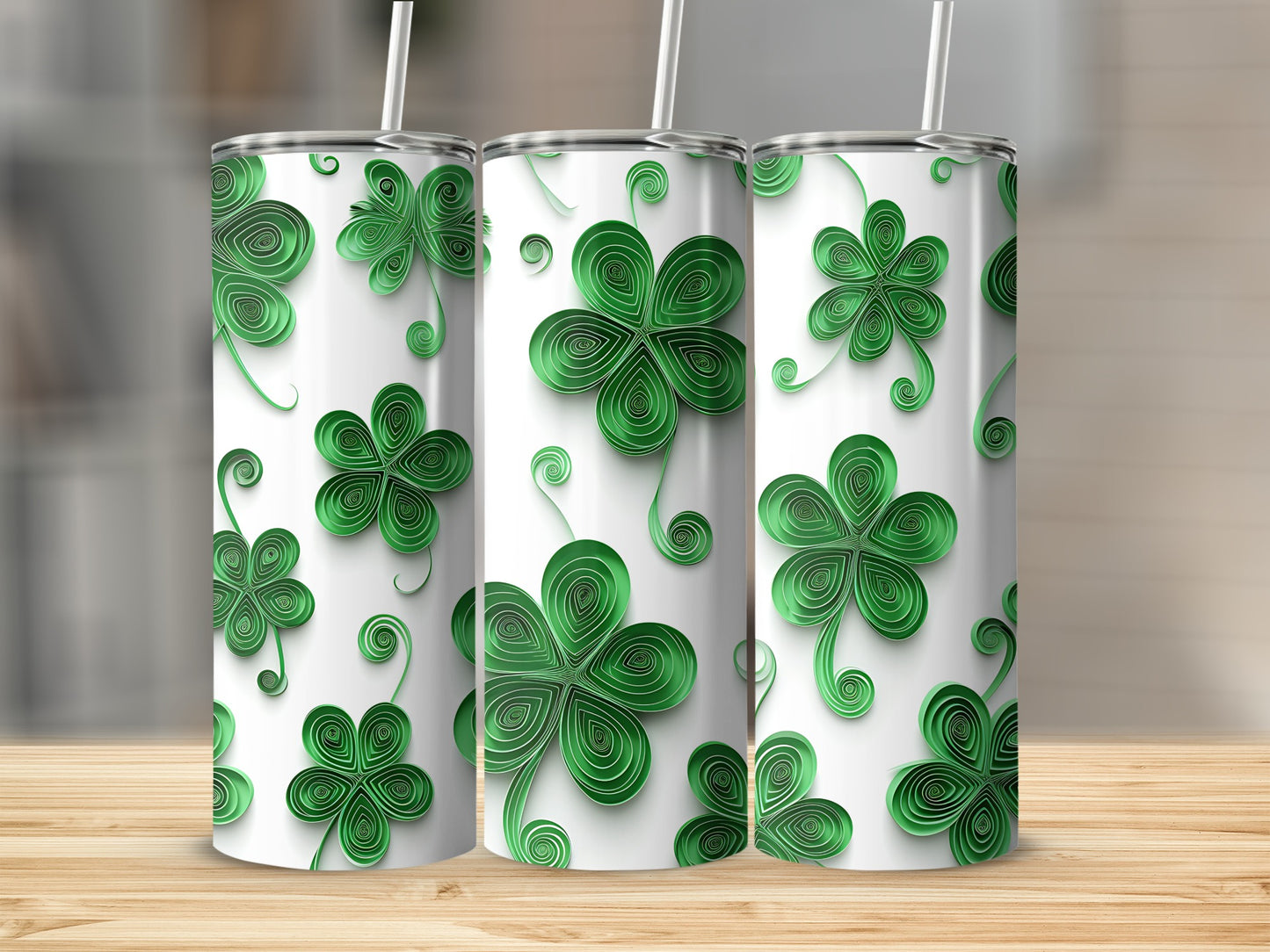 Three tumblers with green shamrock designs arranged side-by-side.