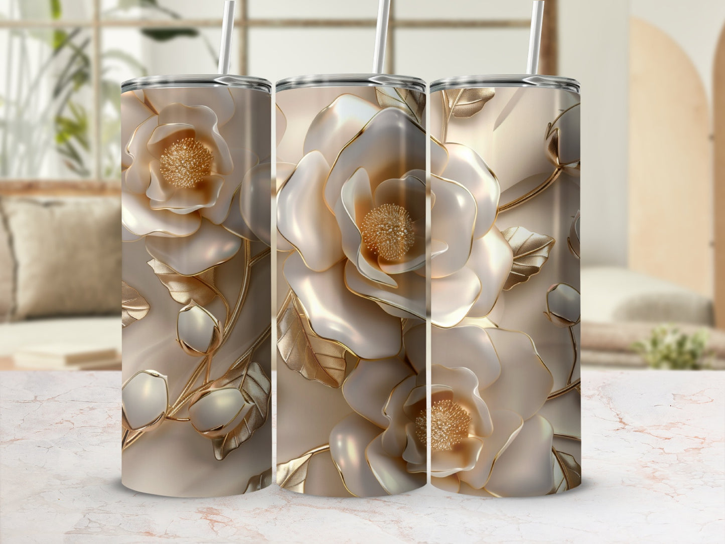 Three tumblers with cream roses and gold accents on a marble surface.