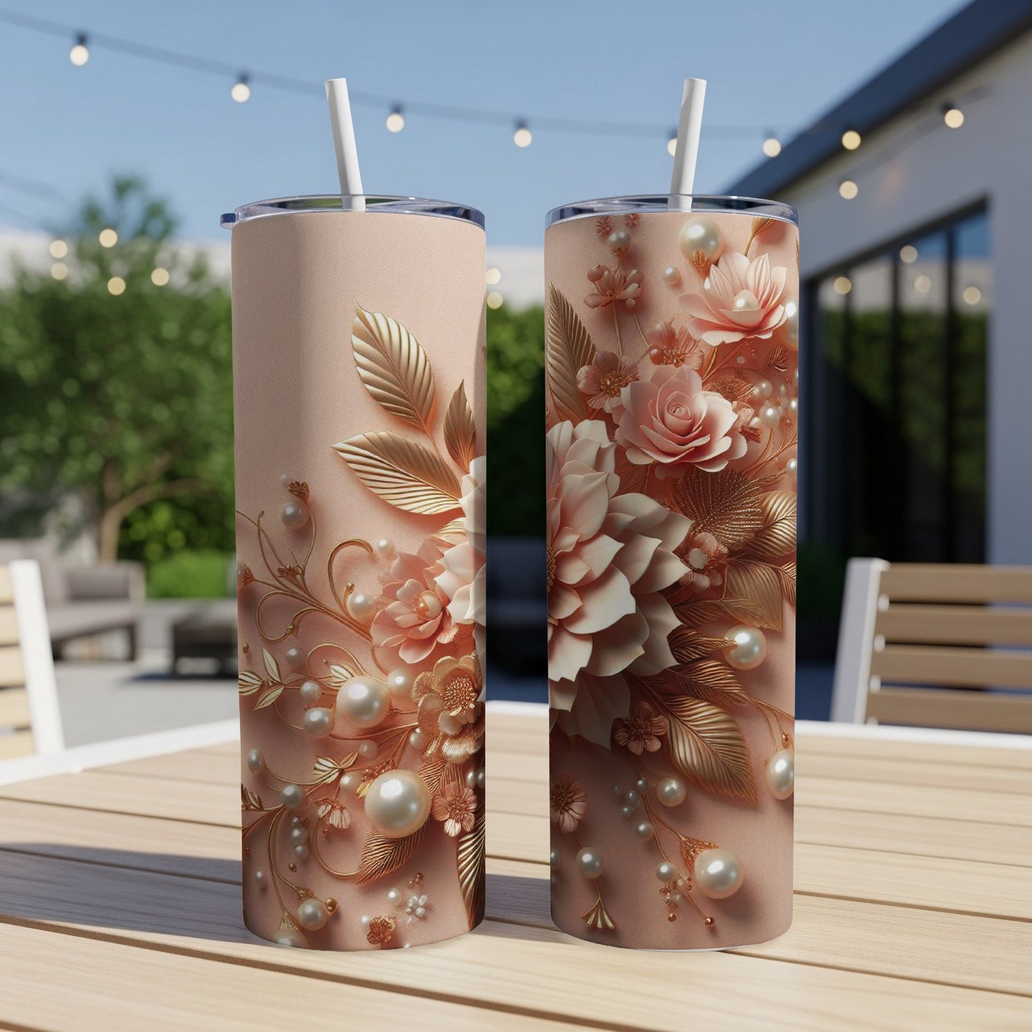 Two pink tumblers with embossed floral and pearl designs on a patio table.