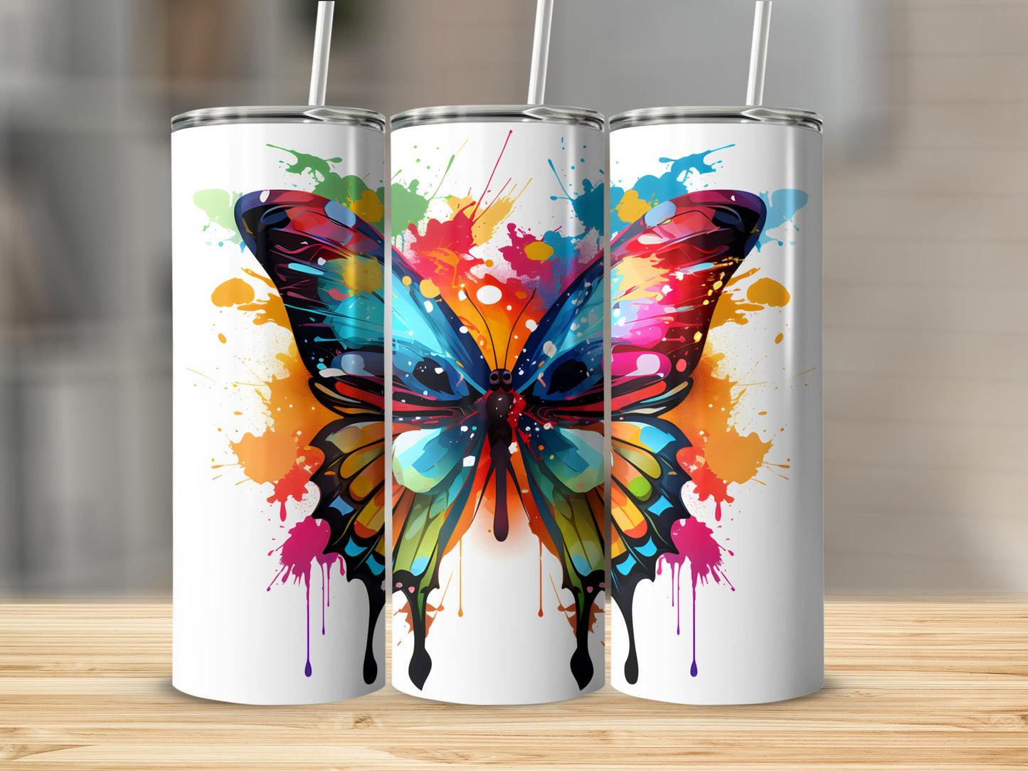 Three white tumblers with colorful butterfly splatter art.