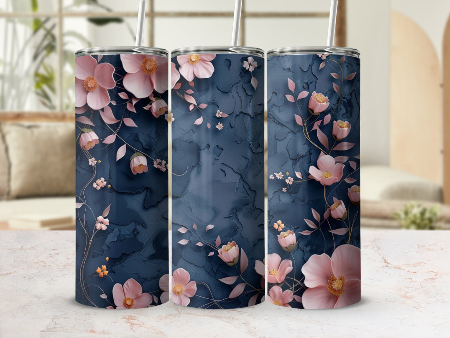 Three tumblers with pink floral and leaf patterns on a dark blue background.