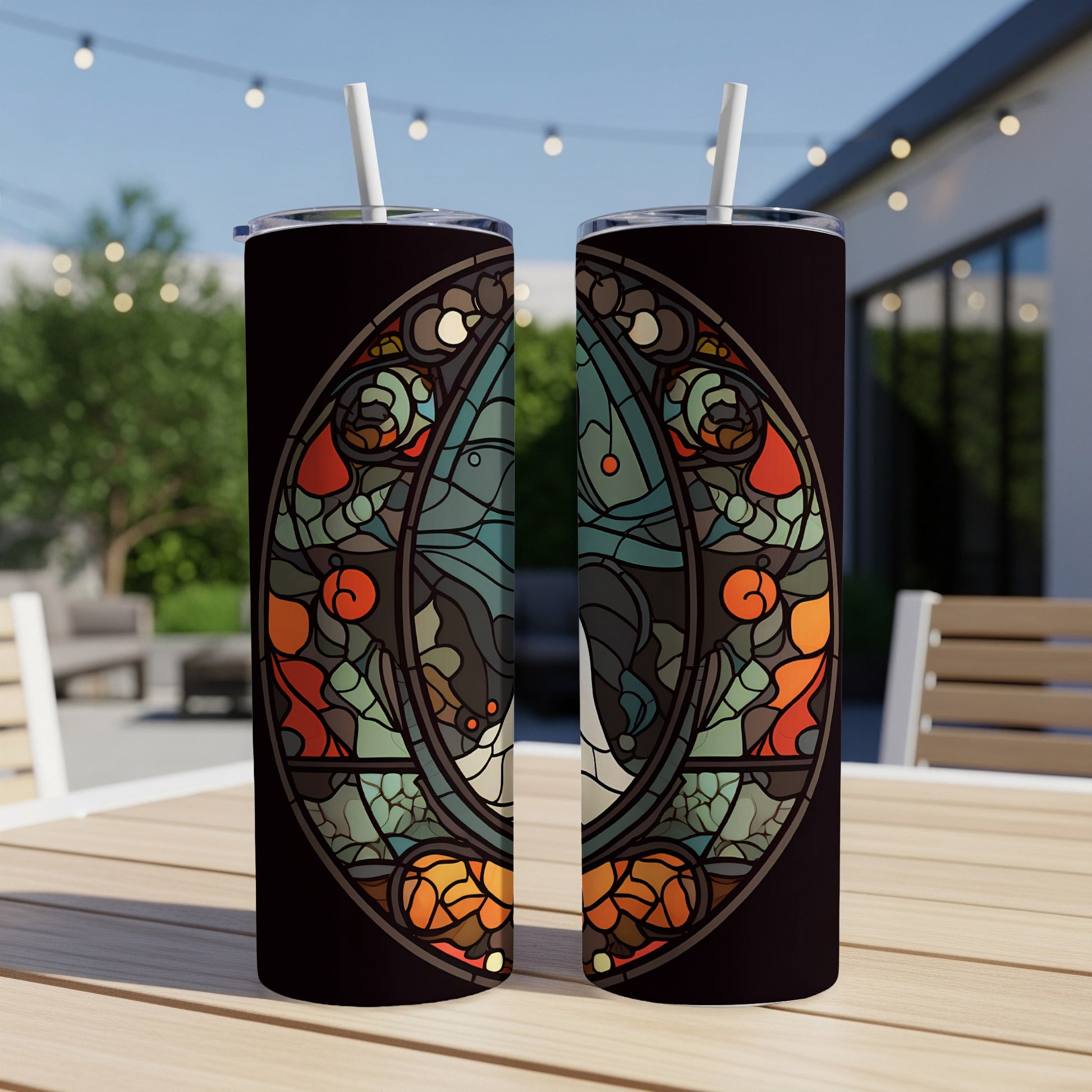 Two tumblers with a dark, stained-glass inspired design of a moth.