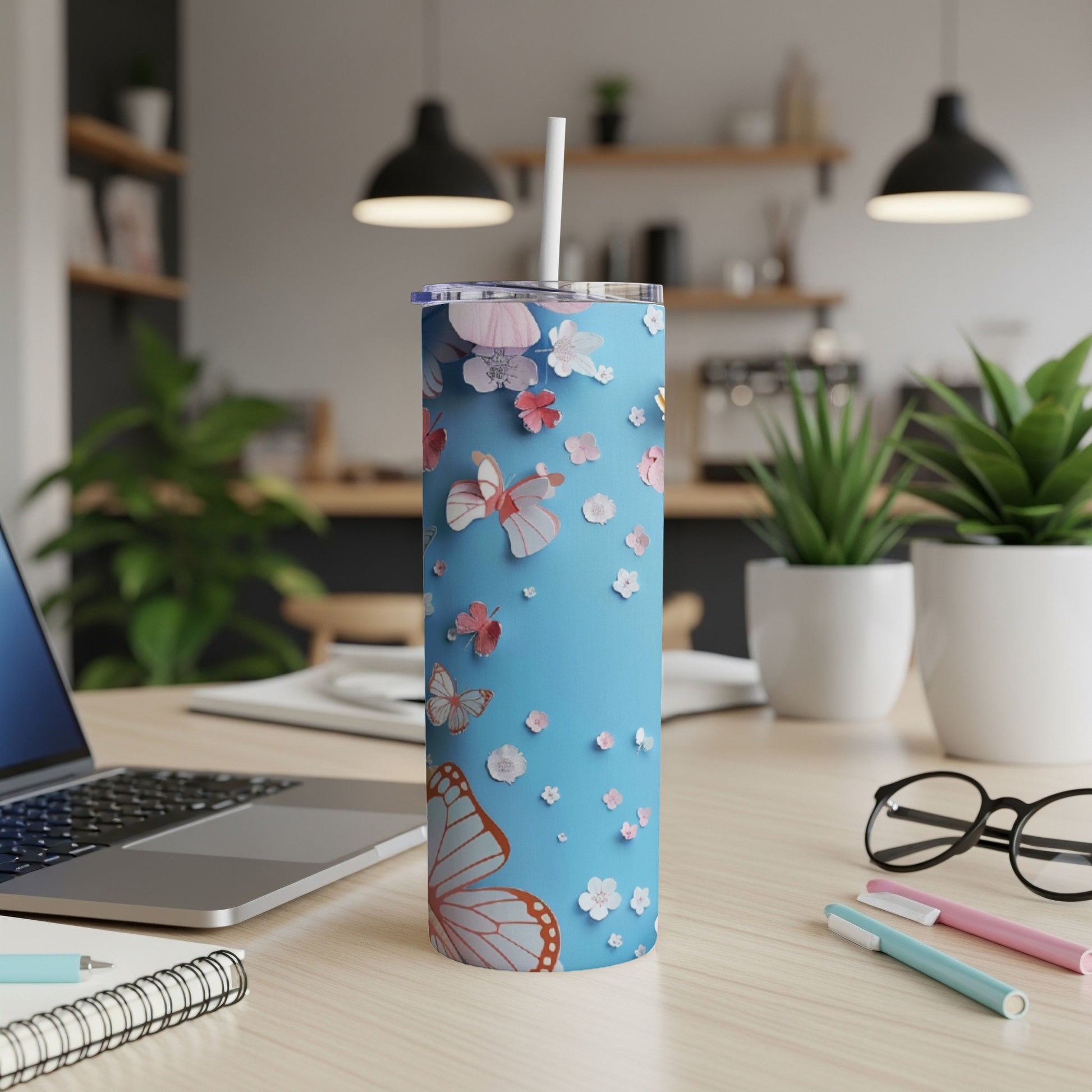 Blue tumbler with butterflies and flowers, white straw.