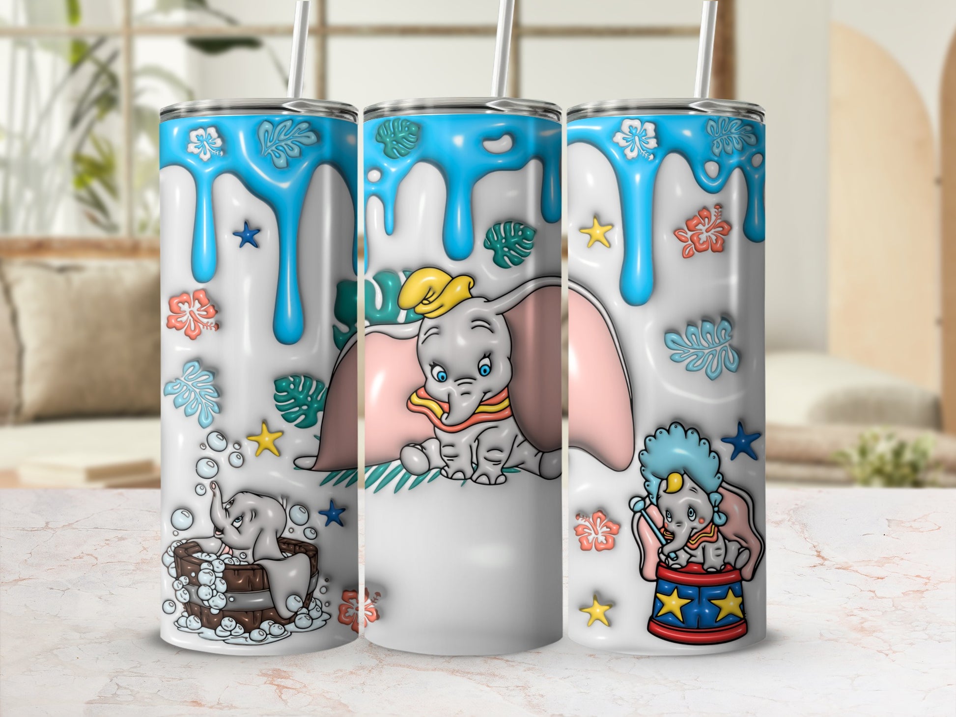 Dumbo the elephant on a white tumbler with blue drips and floral accents.