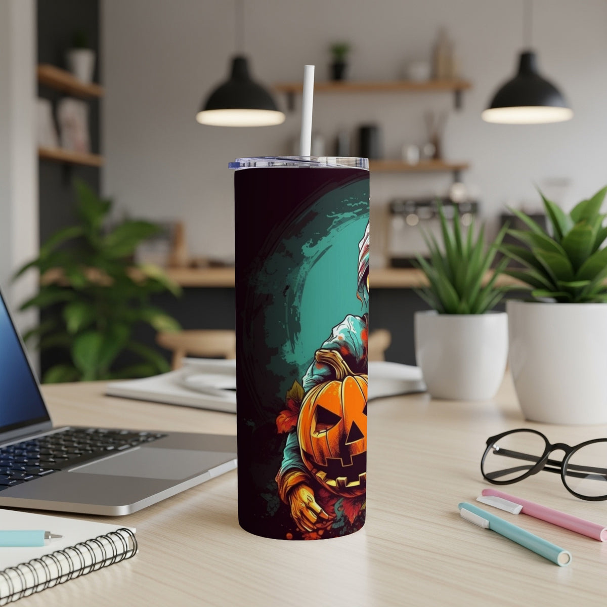 Halloween tumbler with a scarecrow holding a jack-o-lantern.