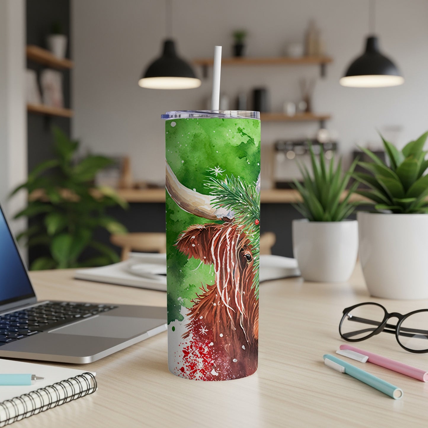 Highland cow and Christmas greenery on a green watercolor tumbler.