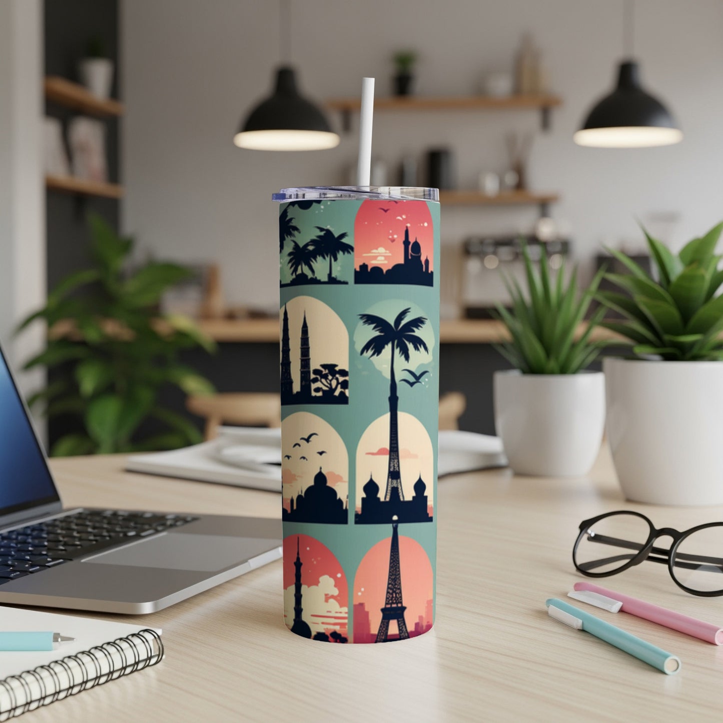 Tall tumbler with travel landmarks silhouette pattern and straw.