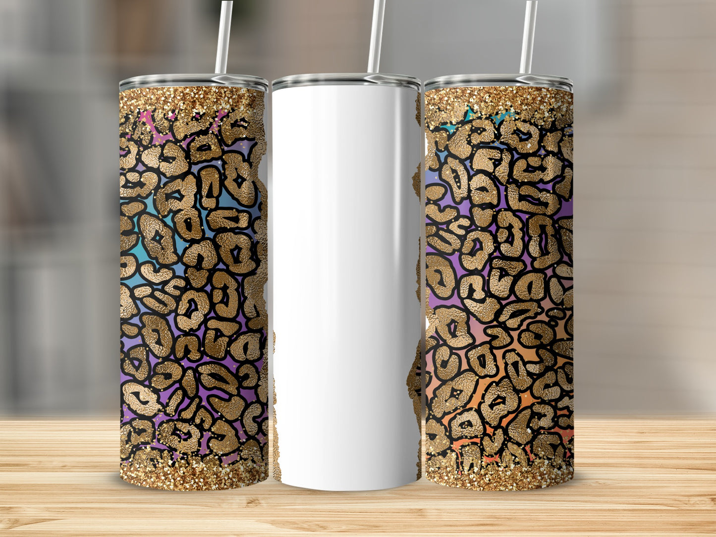 Three tumblers with leopard print and glitter design on wooden surface.