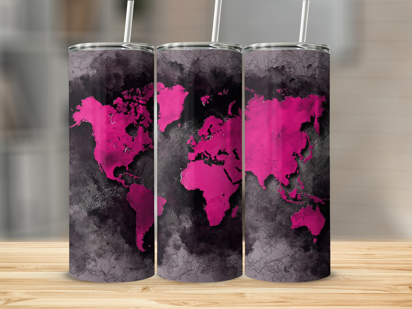Three tumblers with a pink world map design on a dark, abstract background.