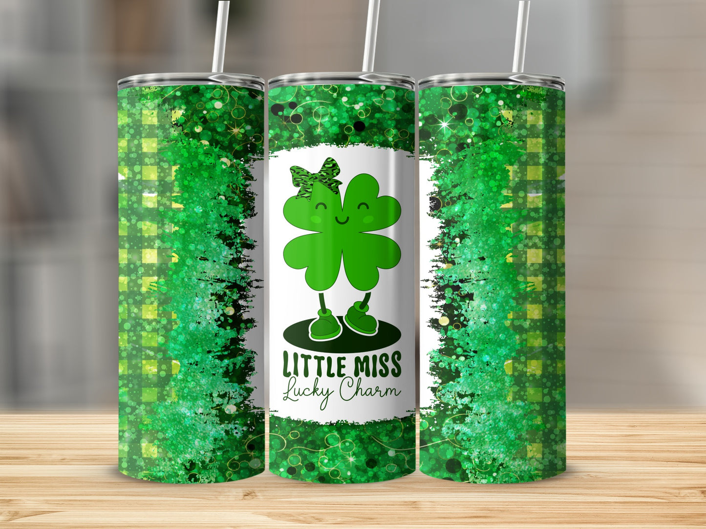 Three tumblers with a green shamrock character and "Little Miss Lucky Charm" text.