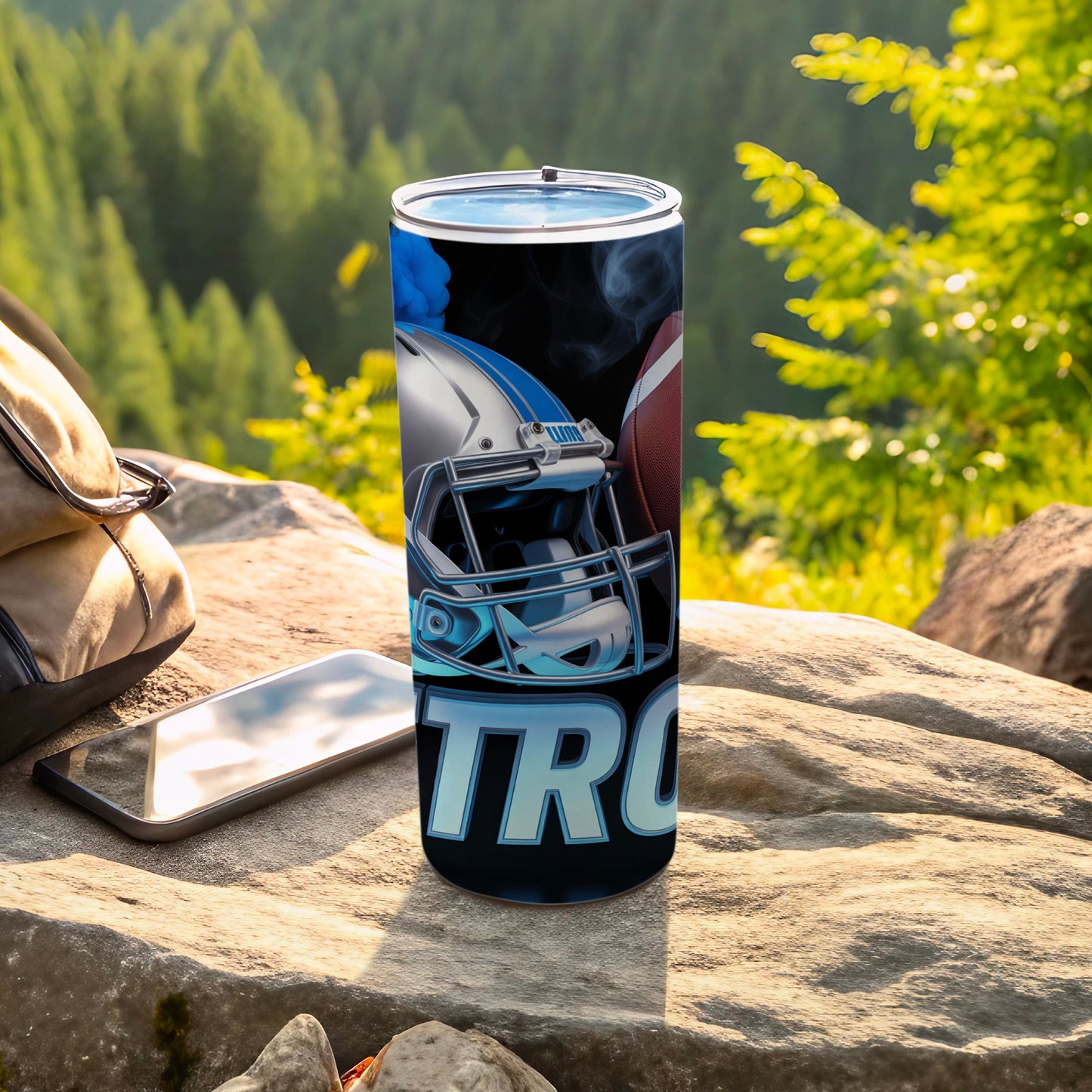 Blue and silver football helmet with a football on a black tumbler.