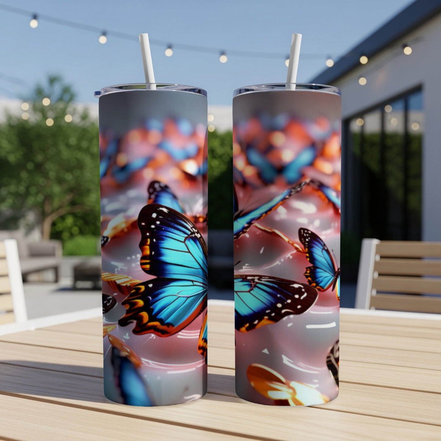 Two tumblers with vibrant blue butterflies on a patio table.