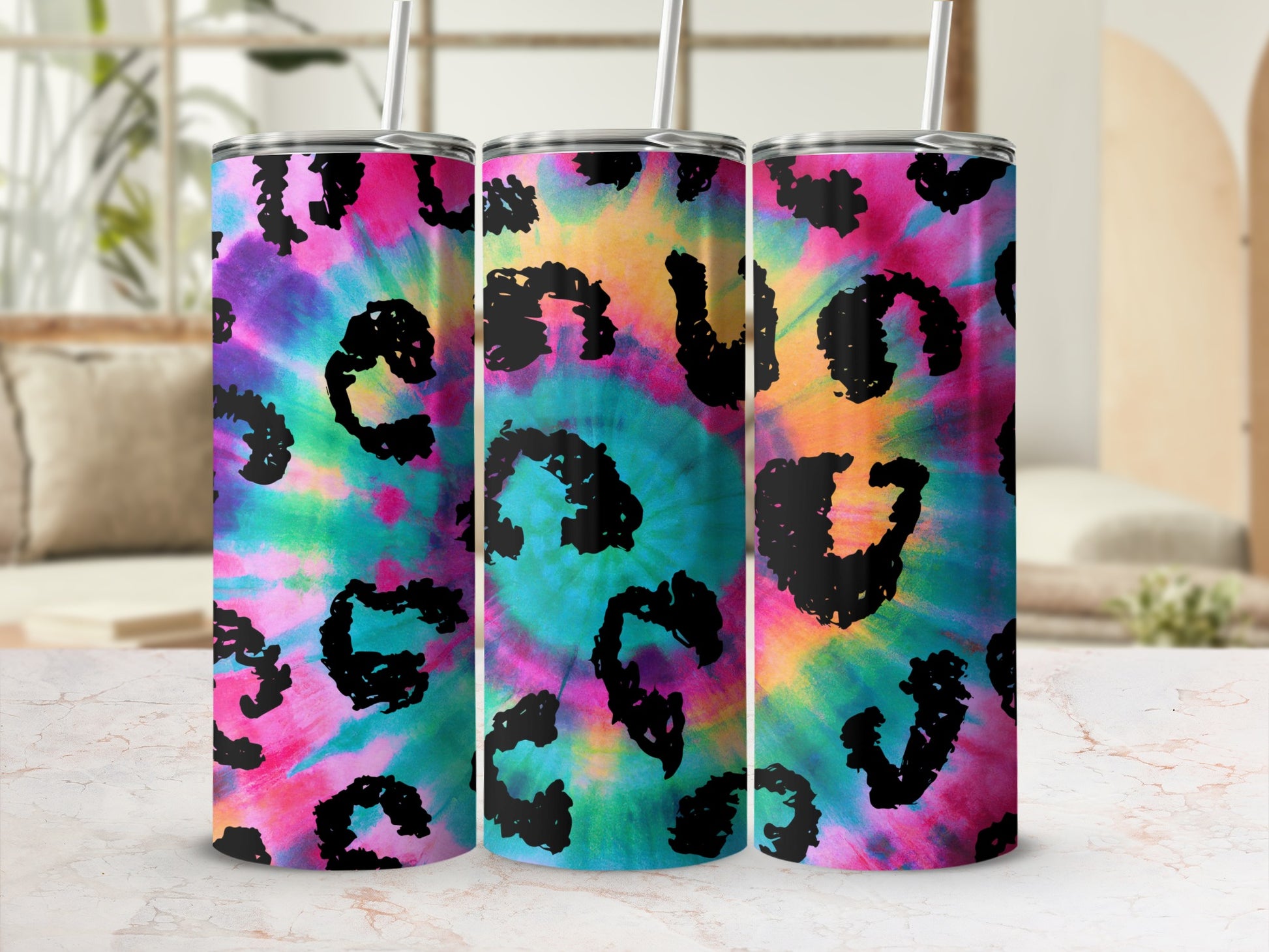 Three tumblers with tie-dye and leopard print designs.