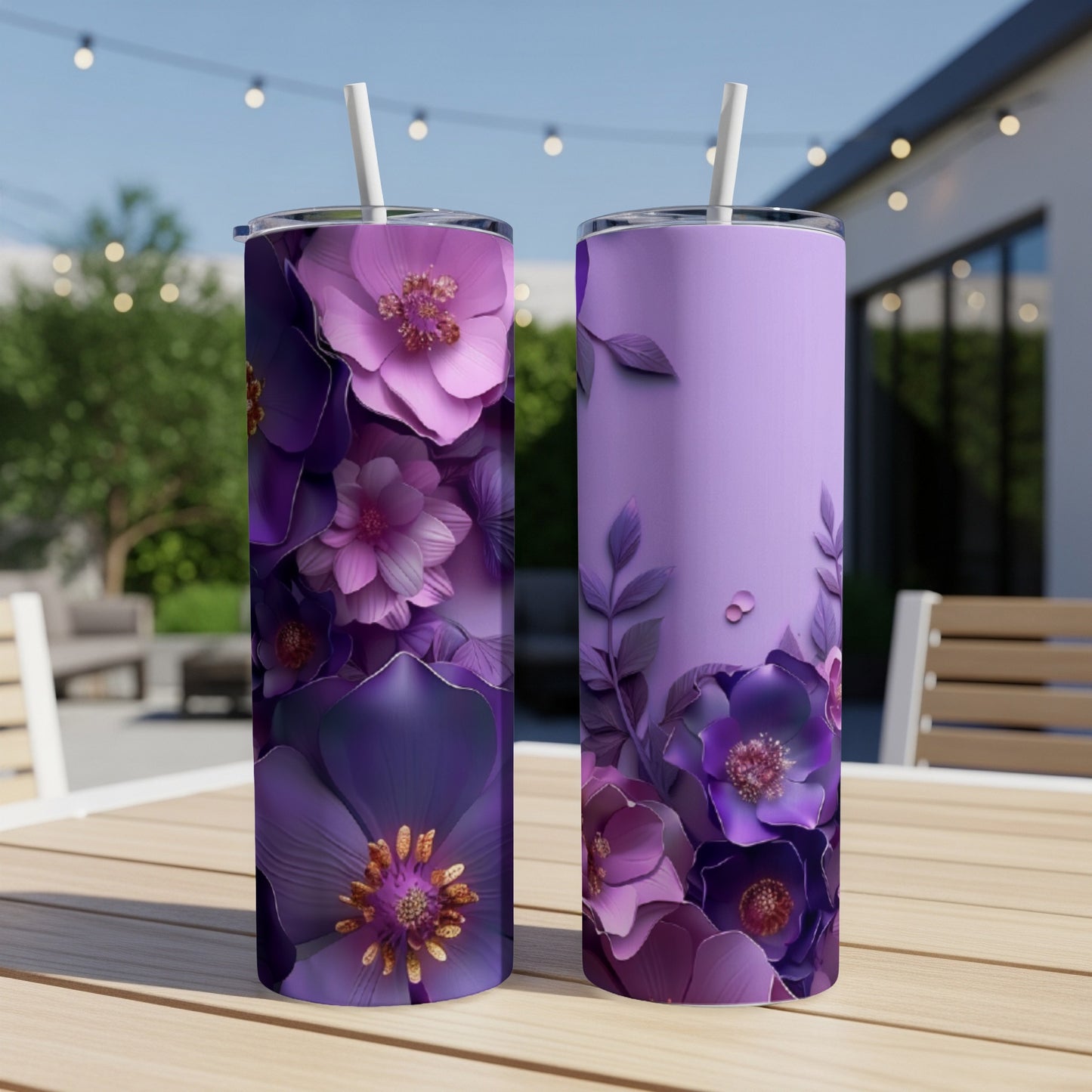 Two purple floral tumblers with straws on a wooden table.