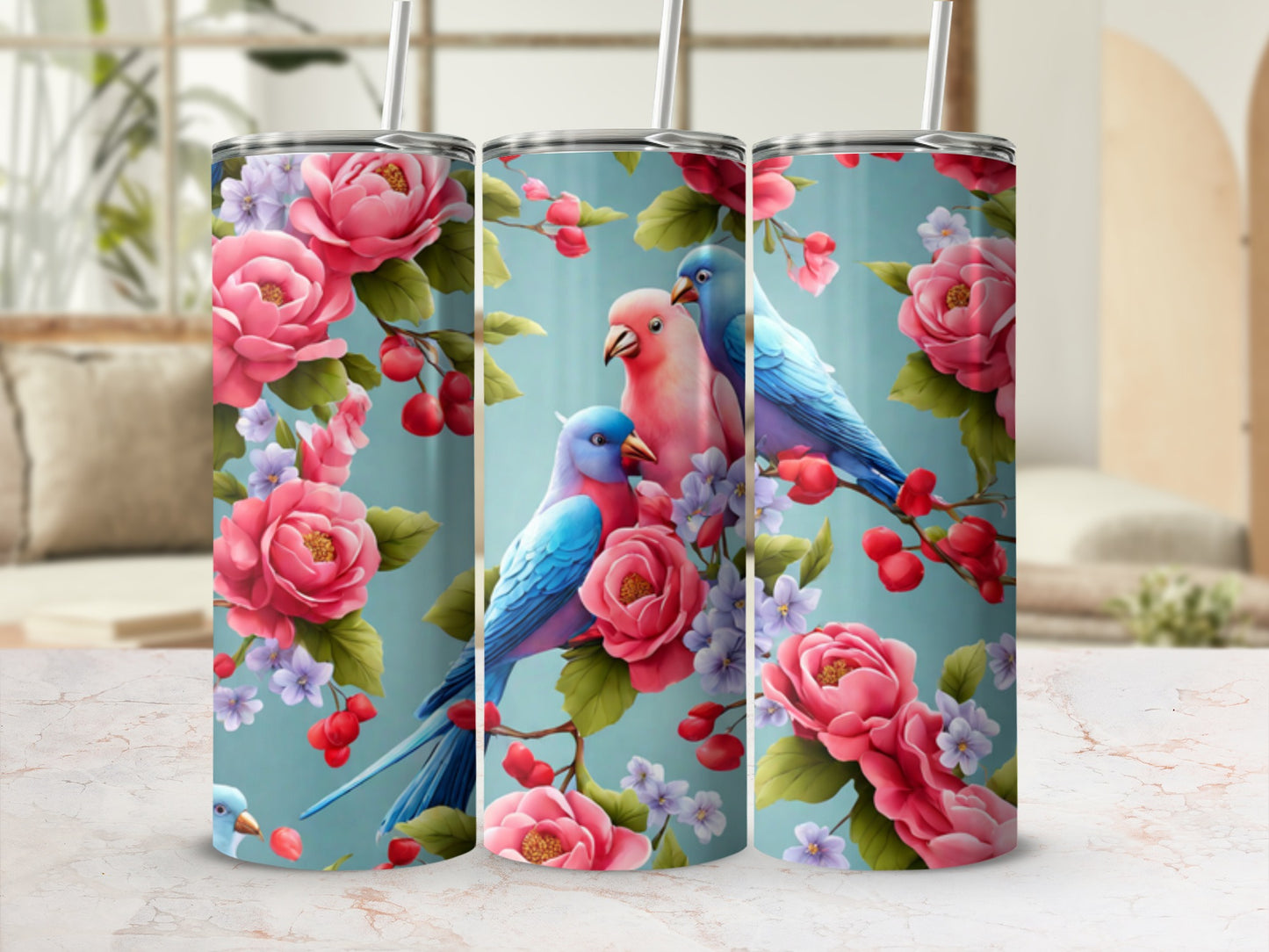 Two blue and one pink parakeet perched on a branch with pink roses.